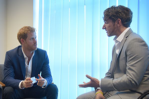 Prince Harry with Dominic Hurley, a brain injury survivor and Headway ambassador, discussing brain injury awareness
