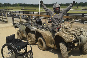 Sportability a muddy quadbike rider and wheelchair, extreme sports