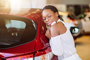 Motability scheme – a woman hugs new car