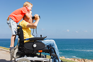 Father and son by the beach enjoying their Accessible Staycations in Norfolk