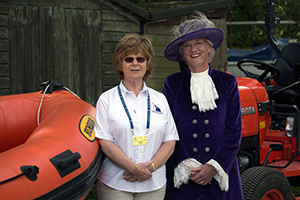 Women stood in front of boats at the Rutland Sailability