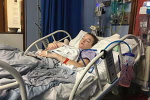 Lucy in hospital bed at South Coast Spinal Unit