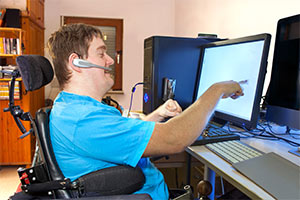 Man working at computer with disability