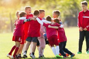 children with adhd playing football together