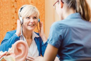 woman at ear clinic suffering from hearing loss
