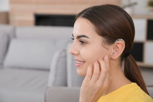 women with hearing aid suffering from hearing loss