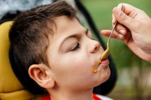 disabled child eating food