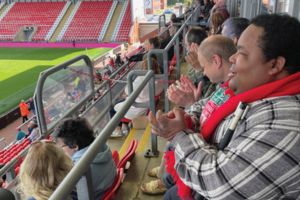service users watching rugby match