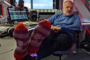 Disabled Entrepreneur Pulls on Purple Socks