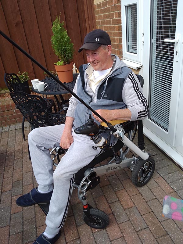 man in wheelchair with fishing rod